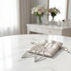 Silver V-shape CZ drop earrings on a satin pouch on marble, gift-ready styling, Luna Dura Dubai