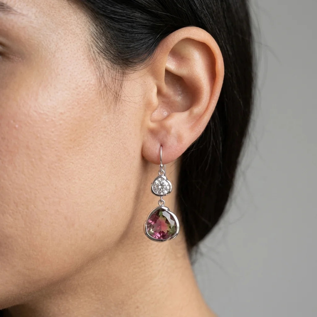 Woman wearing silver watermelon tourmaline simulant and white topaz drop earrings, an October birthday gift in Dubai.