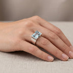Natural sky blue topaz statement ring worn on hand against linen fabric — 925 sterling silver architectural half-bezel setting