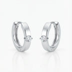 Solitaire Cubic Zirconia huggie earrings in rhodium 925 sterling silver on white background — clicker hoop, front-set stone