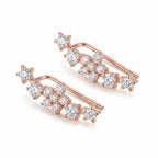 Angled view of the stackable CZ silver climber earrings showcasing the delicate plume silhouette and the bright polish rose gold finish.