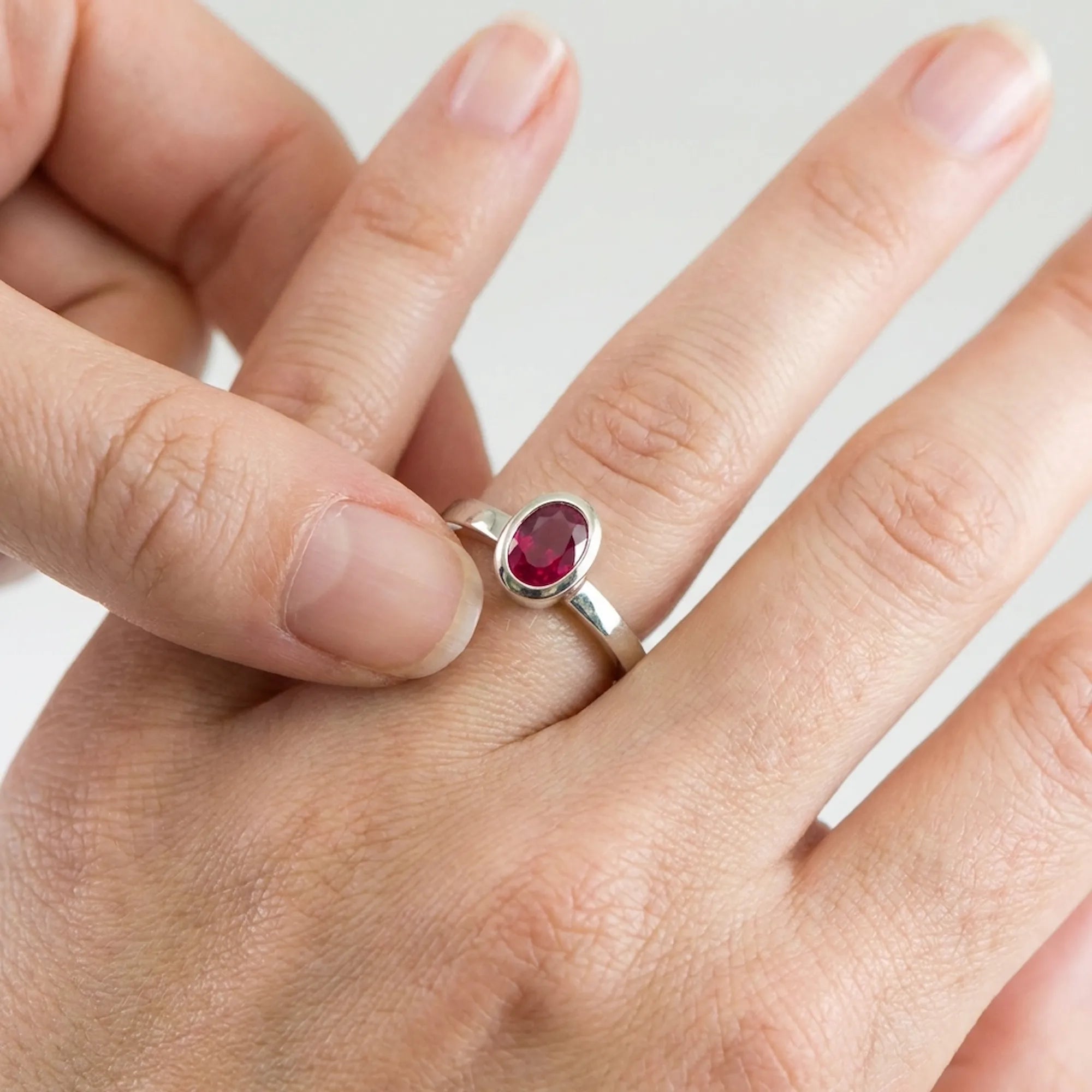 stackable silver ring worn with other rings demonstrating how to layer a 925 silver ring for women