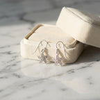 Starfish silver drop earrings by a cream gift box on marble, gift-ready from Luna Dura Dubai