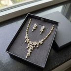 18k gold-plated cubic zirconia waterfall necklace and earring set presented in a luxury dark grey gift box in Dubai.