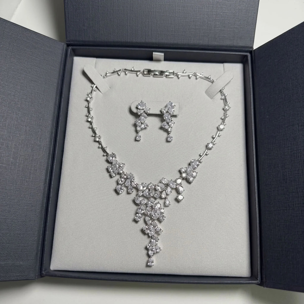 Rhodium-plated cubic zirconia statement waterfall necklace and earring set presented in a luxury gift box in Dubai.