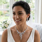 Bride wearing a statement rhodium-plated cubic zirconia waterfall Y-necklace and earring suite indoors in Dubai.