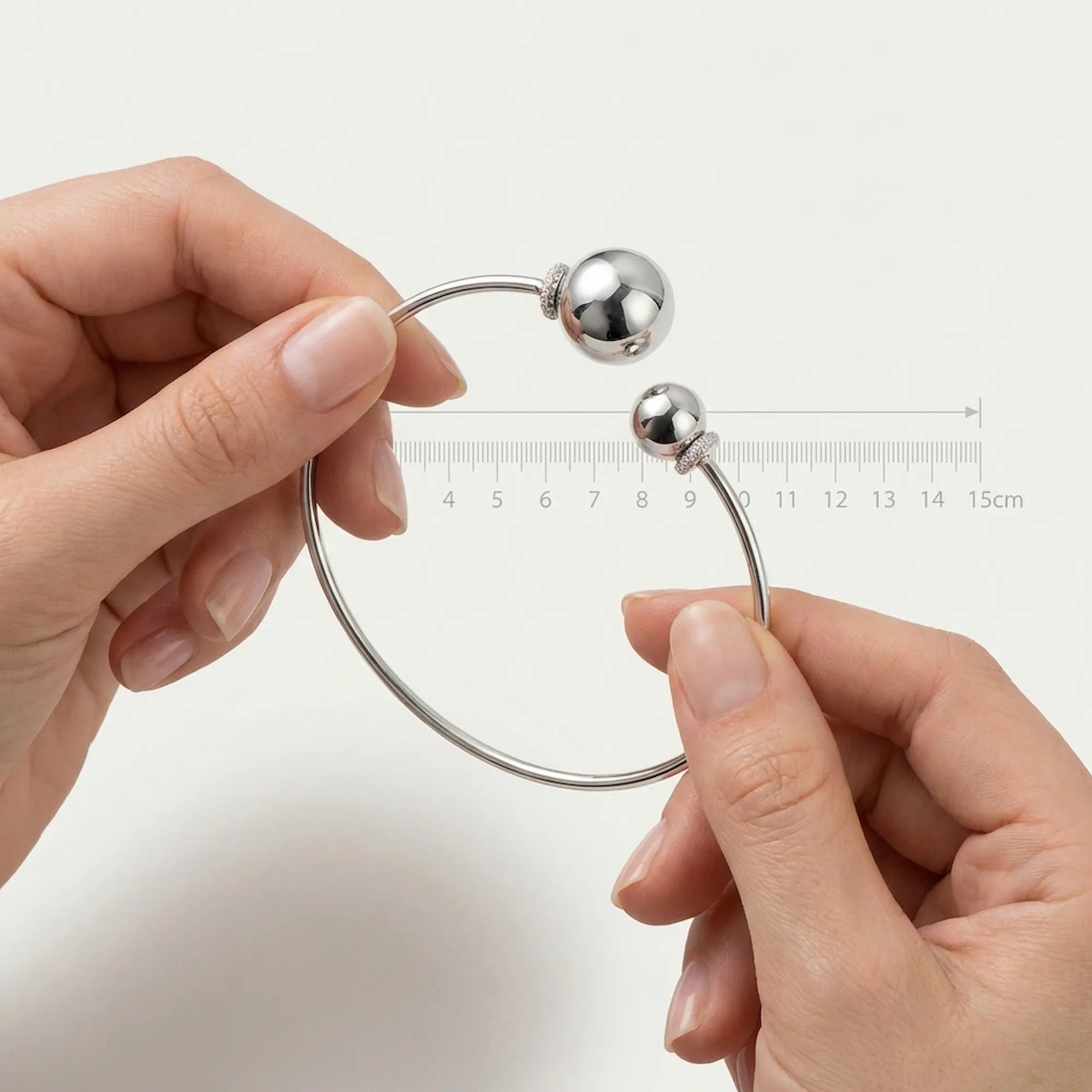 Hands holding the open cz sterling silver choker next to a ruler showing the 15cm width for accurate size reference.