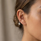 Close-up of a woman wearing the sterling silver ear cuff no piercing on her conch, demonstrating the elegant 24 mm length and scale.