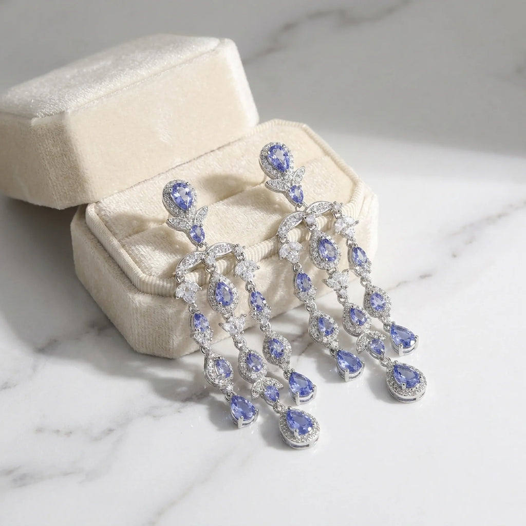 Tanzanite chandelier earrings in a cream velvet gift box, rhodium-plated 925 silver, Luna Dura Dubai.