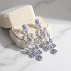 Tanzanite chandelier earrings in a cream velvet gift box, rhodium-plated 925 silver, Luna Dura Dubai.