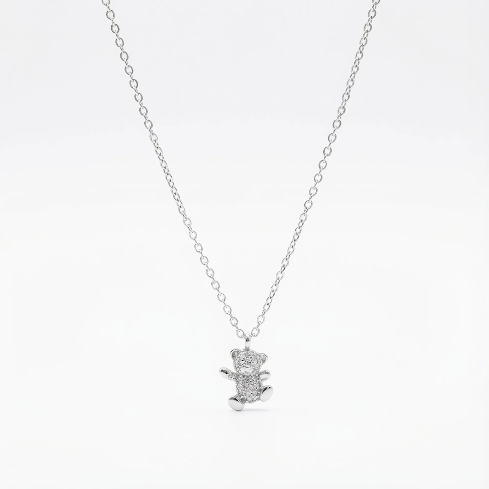 Pavé CZ teddy bear pendant necklace in rhodium 925 sterling silver — full stone coverage on bear form, cable chain and lobster clasp on white background