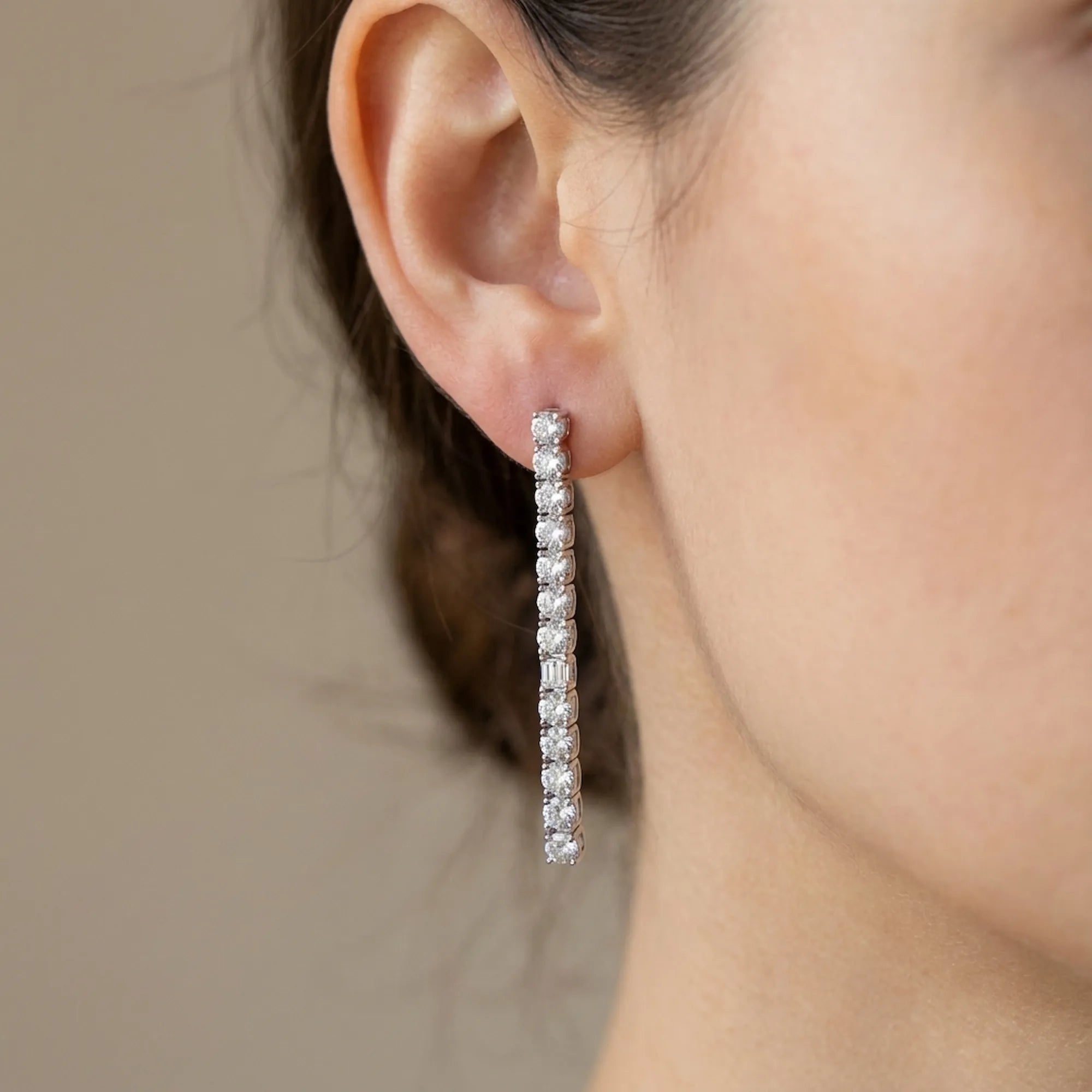 Close-up of CZ tennis drop earring on ear — 40mm prong-set cubic zirconia line and post back detail rhodium 925 silver Dubai