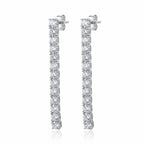 Tennis drop earrings — 40mm continuous CZ line in rhodium 925 sterling silver, four-prong setting, post back on white background