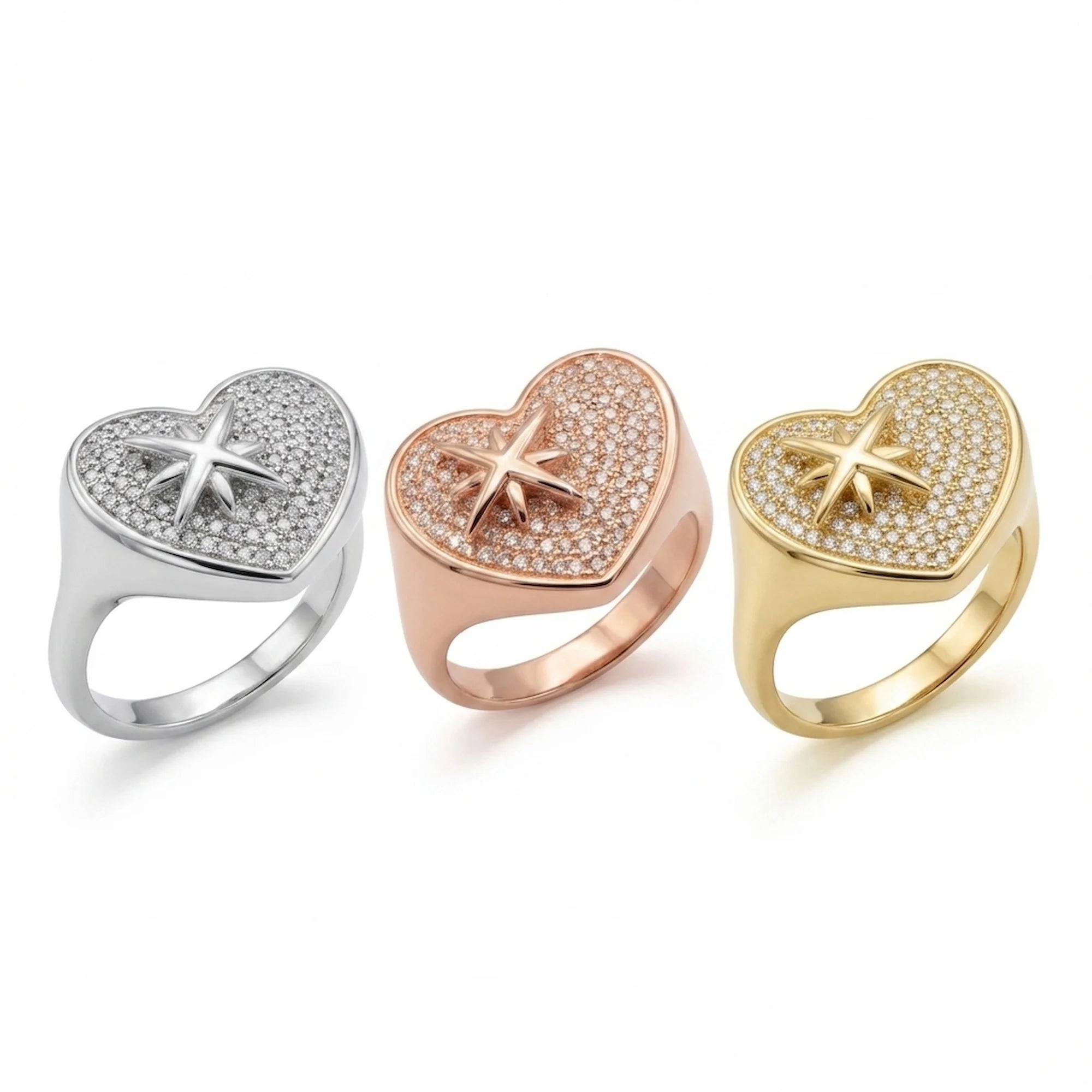 Rhodium, rose gold, and gold 925 silver pavé heart rings with cubic zirconia photographed in Dubai.