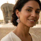 Red enamel tulip drop earring in 925 sterling silver worn on model with Dubai Opera visible in background