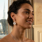 Silver 925 sterling silver tulip drop earring on model indoors with city tower view through window