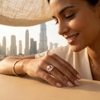 Red enamel tulip medallion ring on model hand with Dubai skyline in background