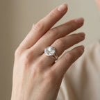 Satin silver tulip medallion ring worn on hand showing three-track bypass band detail