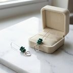 Turquoise chip and heart silver drop earrings beside open cream velvet gift box on marble — gifting presentation