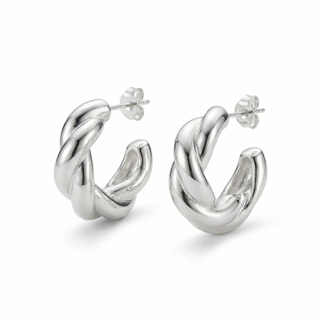 Sculptural twisted 925 sterling silver hoop earrings on white background — 15mm, post-back closure, hollow-backed form