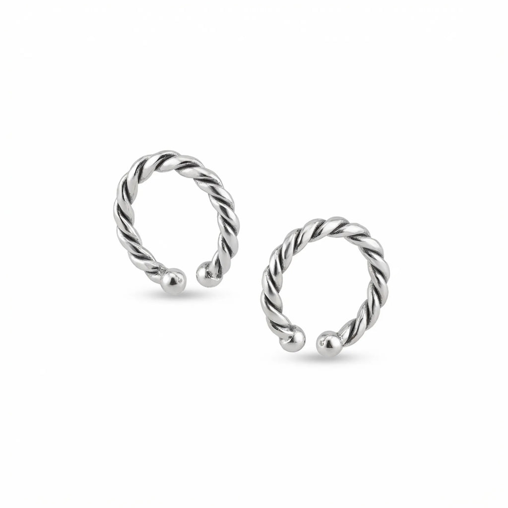 Pair of twisted rope ear cuffs in oxidized 925 sterling silver with ball ends, isolated on white background UAE