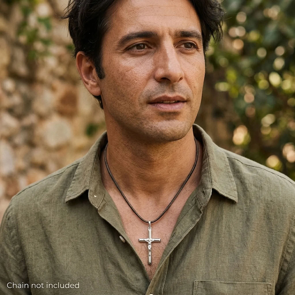 Man wearing a solid 925 sterling silver tubular crucifix pendant on a styling cord, cord not included.