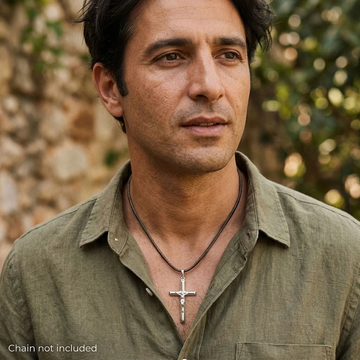 Man wearing a solid 925 sterling silver tubular crucifix pendant on a styling cord, cord not included.