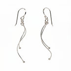 Wave drop earrings in 925 sterling silver on white background, two intertwined wires with ball tips, 52mm