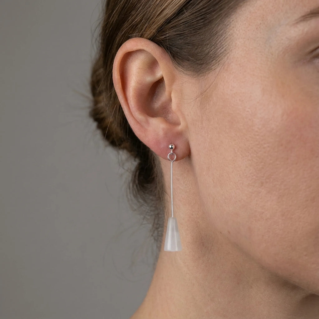 Natural white stone silver drop earring worn on the ear, 50 mm sterling silver rod, Dubai UAE