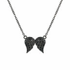 Front view of Luna Dura's women's black jewelry wing pendant in sterling silver featuring black zircon on a clean white background.